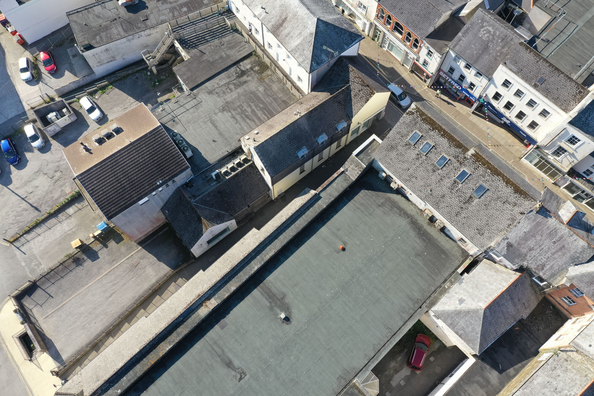 Top-down drone mapping photo of flat and slate roofs behind Fore Street, Bodmin, Cornwall, showing the whole site