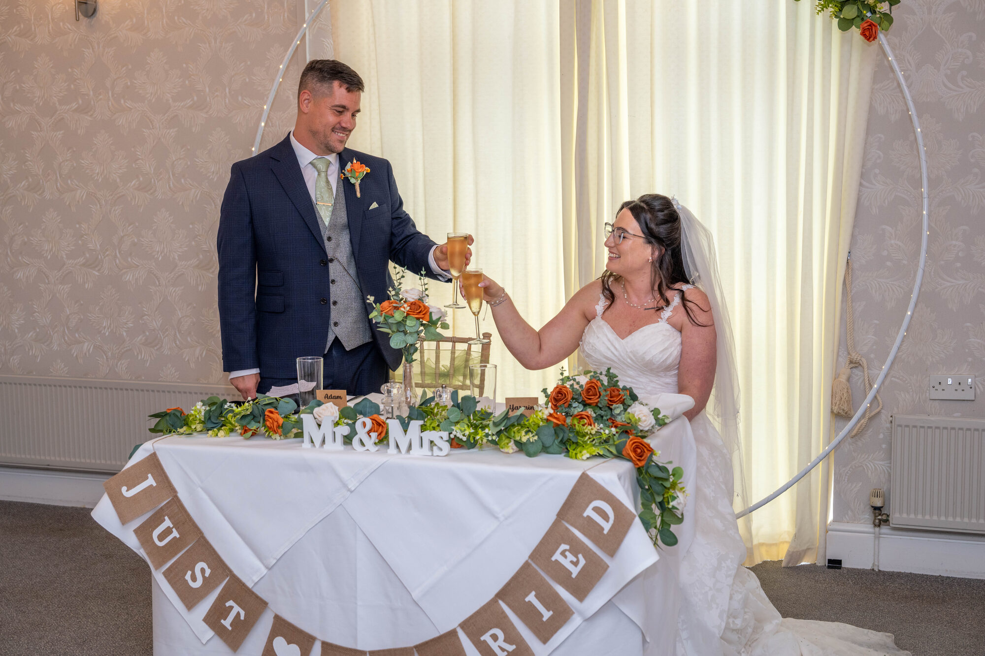 Bride and groom sharing a cheers during groom's speech