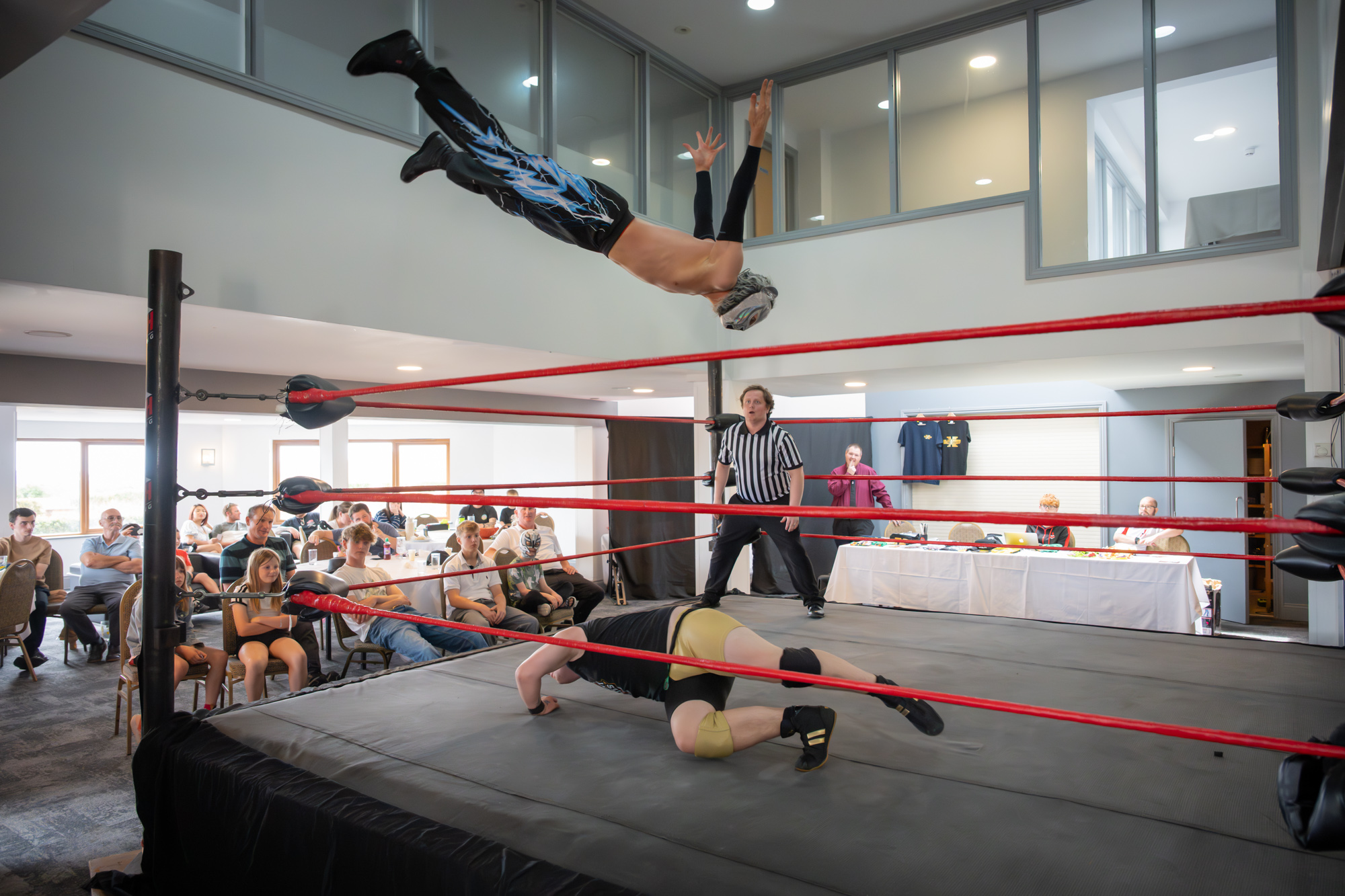 Leo Skye mid-air as Johnny Bates evades, REACH Wrestling Neuro Rumble