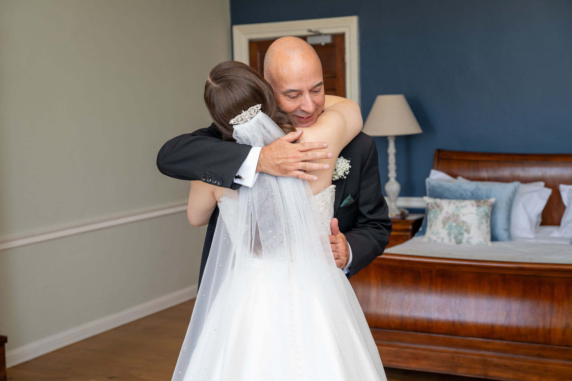 Bride hugging her father during the first look moment