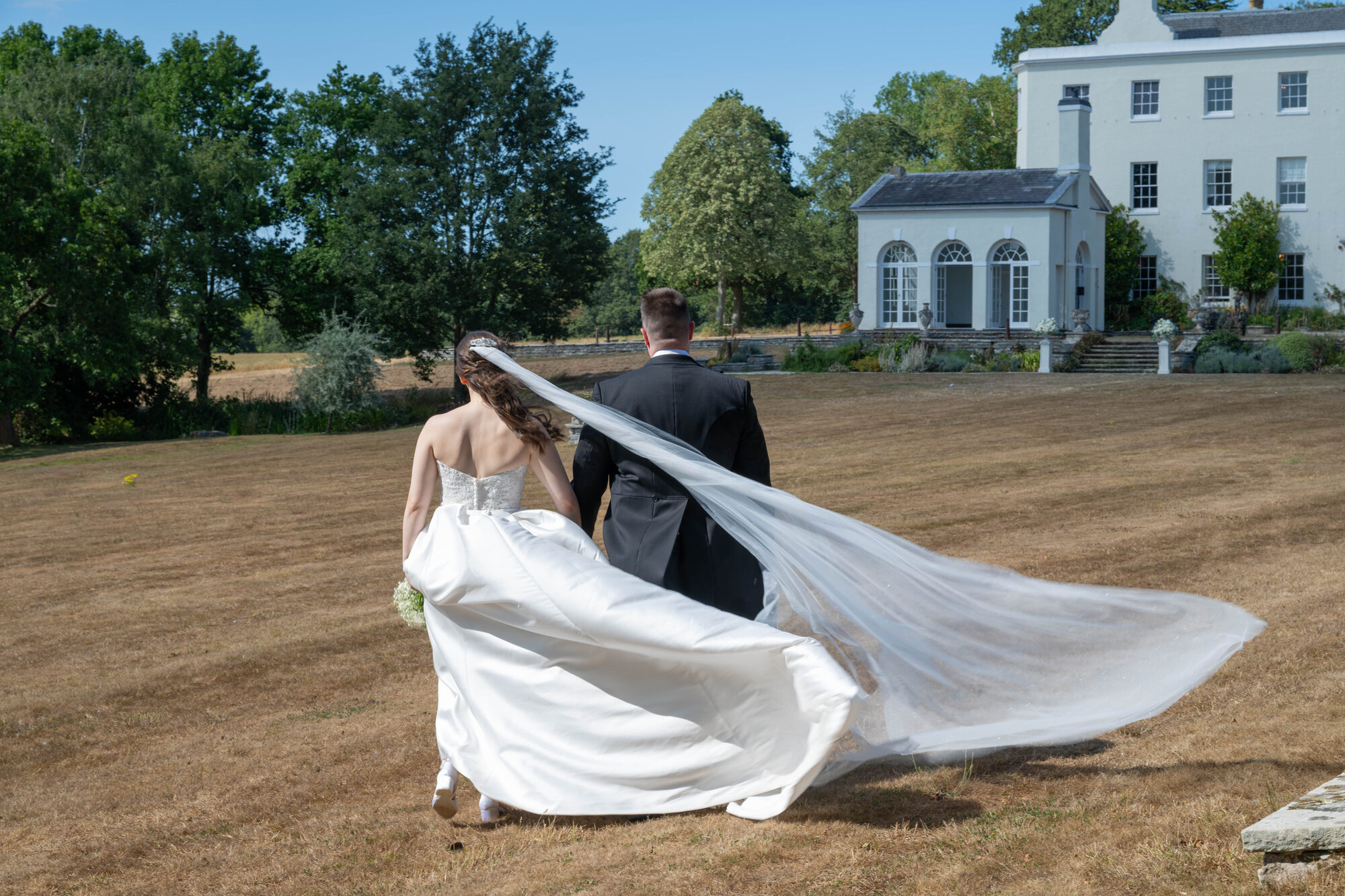 Couple walking back to manor after visiting walled garden