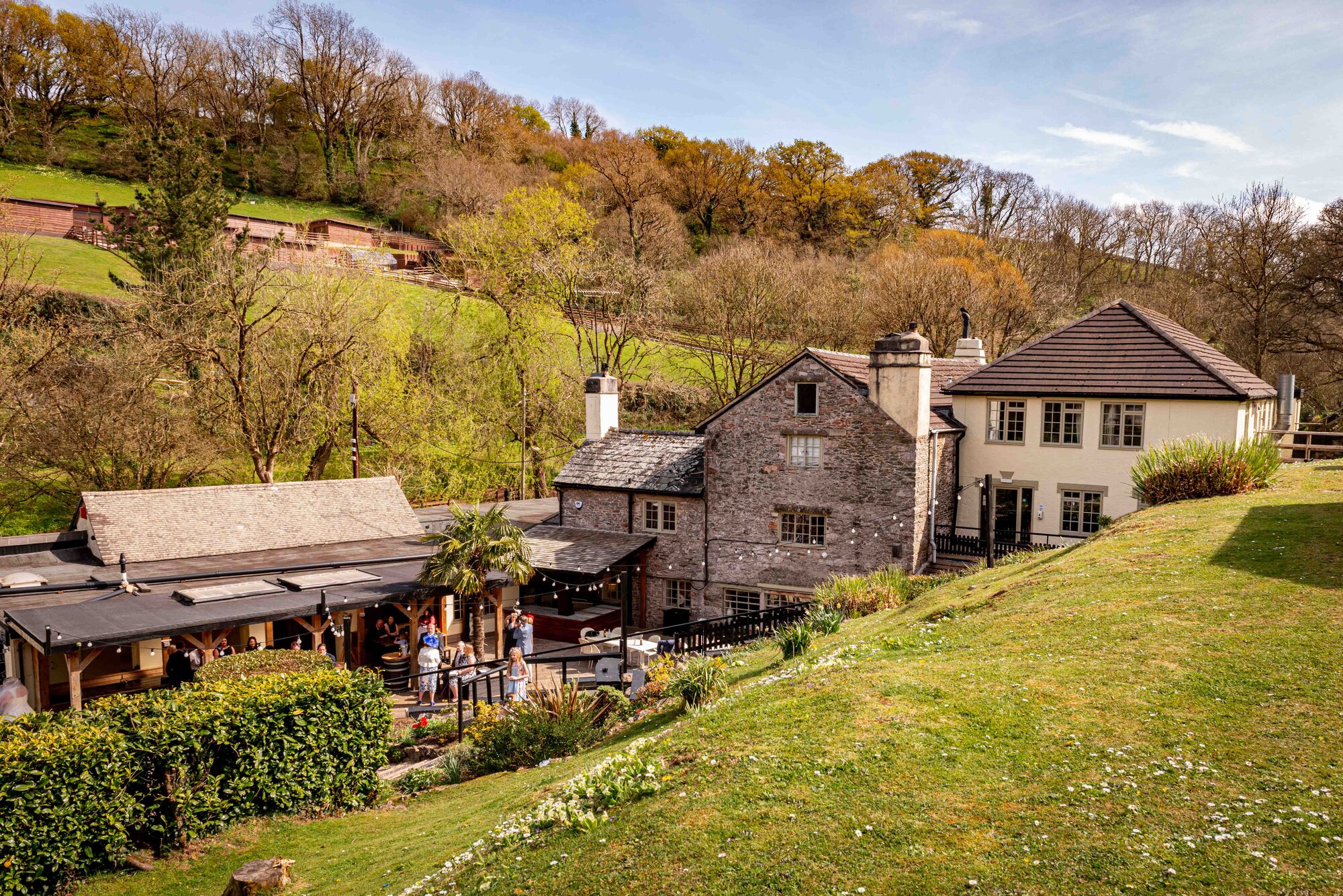 Rustic exterior view of Bickley Mill wedding venue with lush greenery