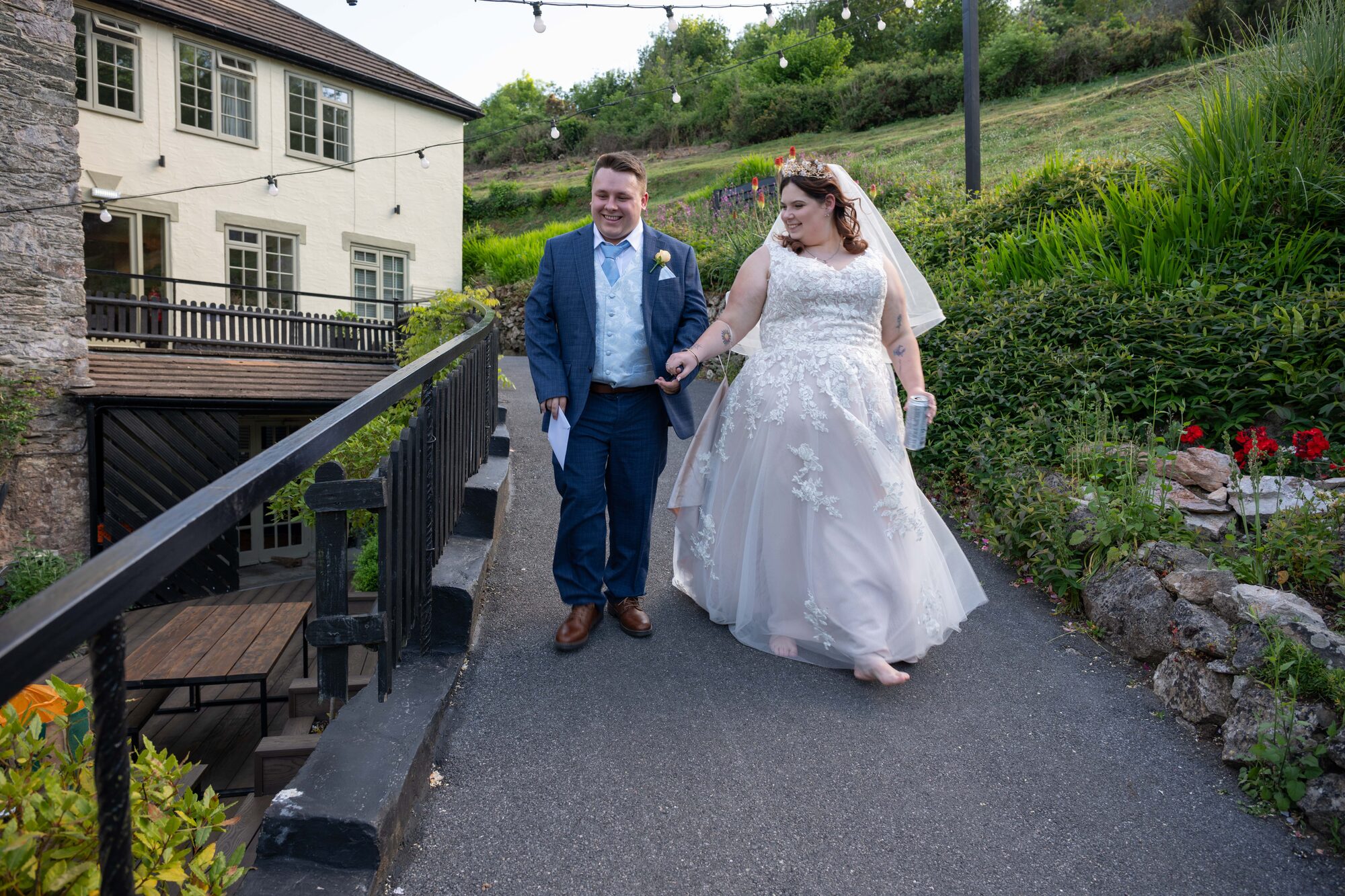 Bride and groom walking together down the garden path at Bickley Mill wedding