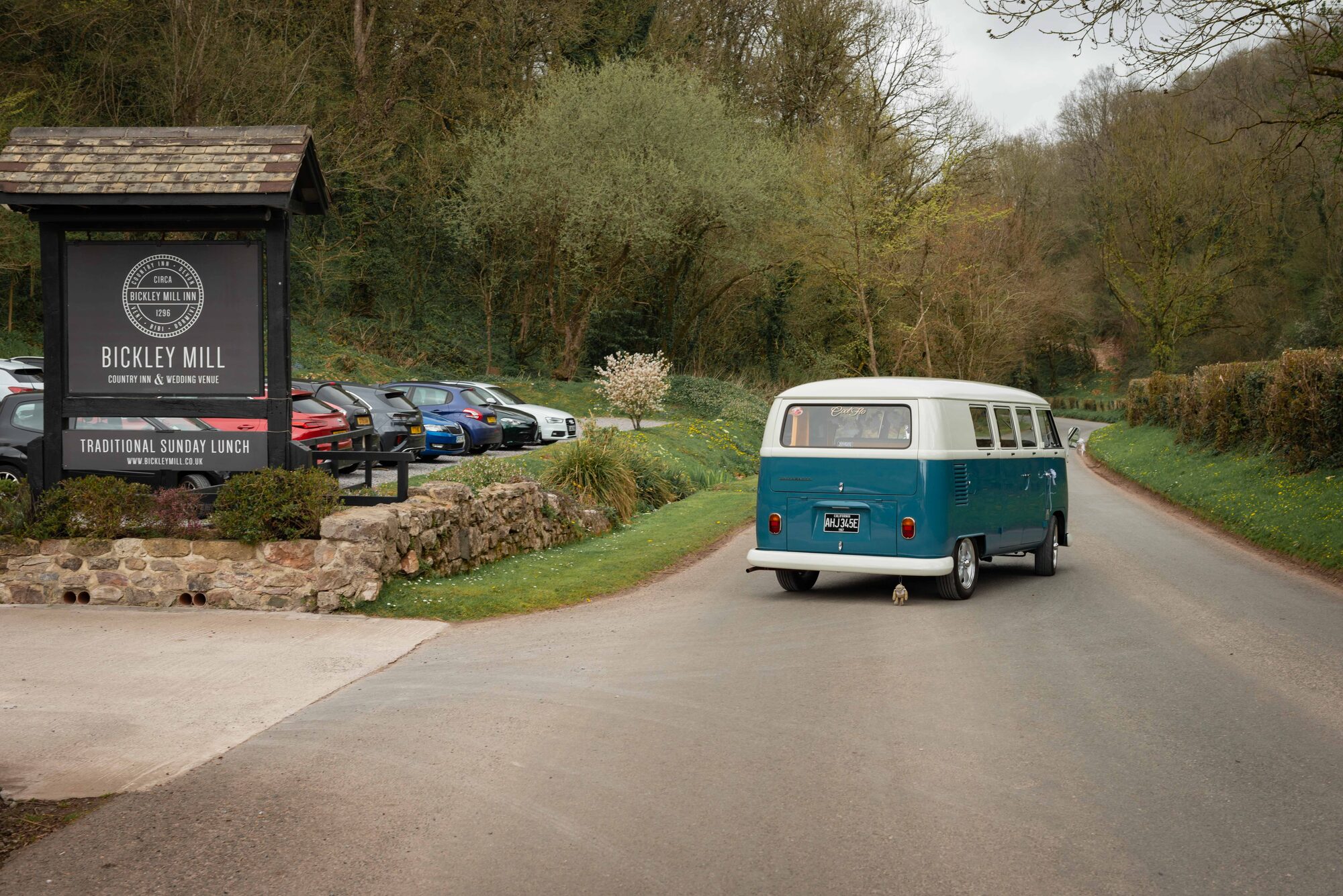 Bride and groom in classic wedding camper van leaving Bickley Mill